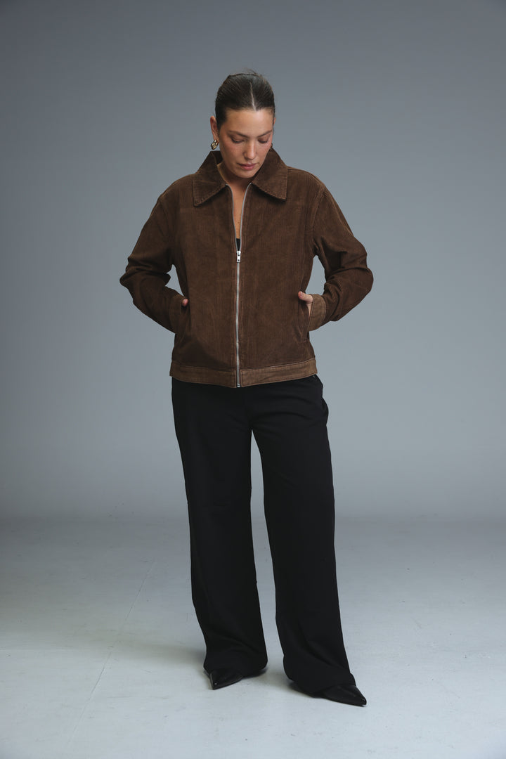 Brown corduroy jacket bomber style with contrasting tan trim along hem and cuffs shown from the front