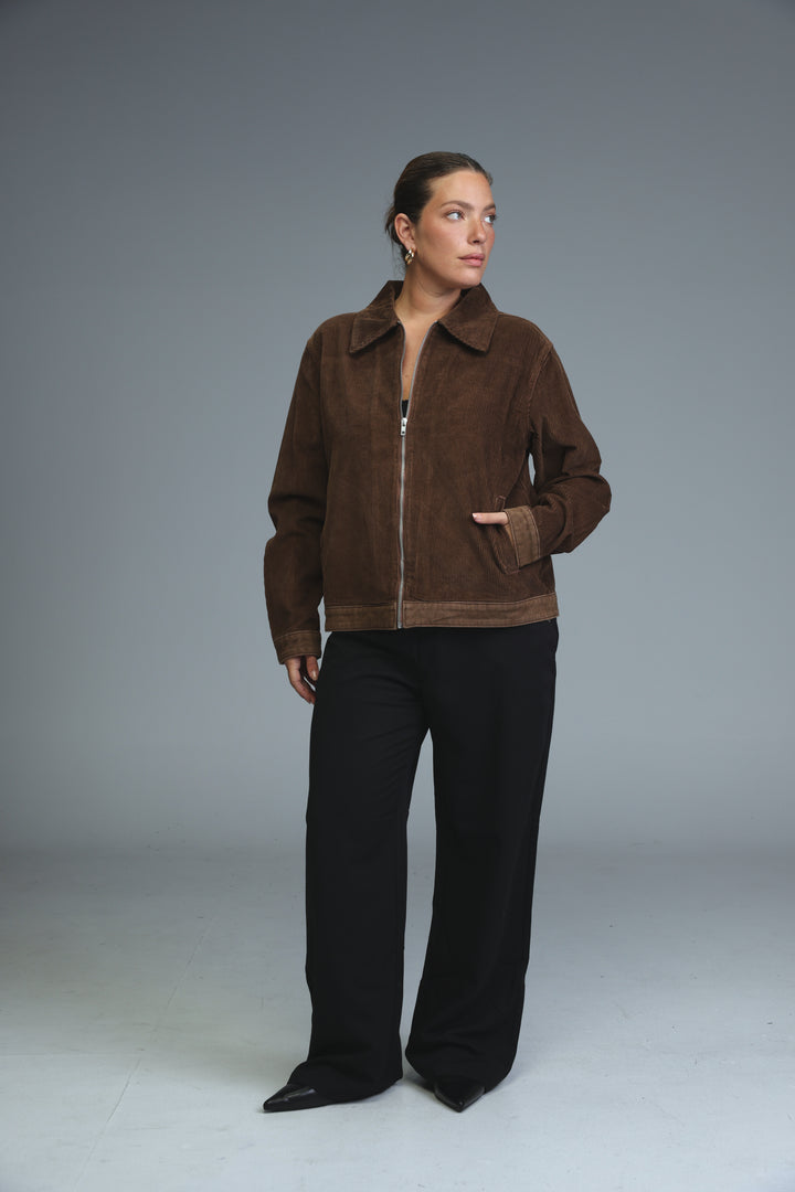Corduroy brown jacket with contrasting darker brown trim along the front zipper and cuffs shown from the front
