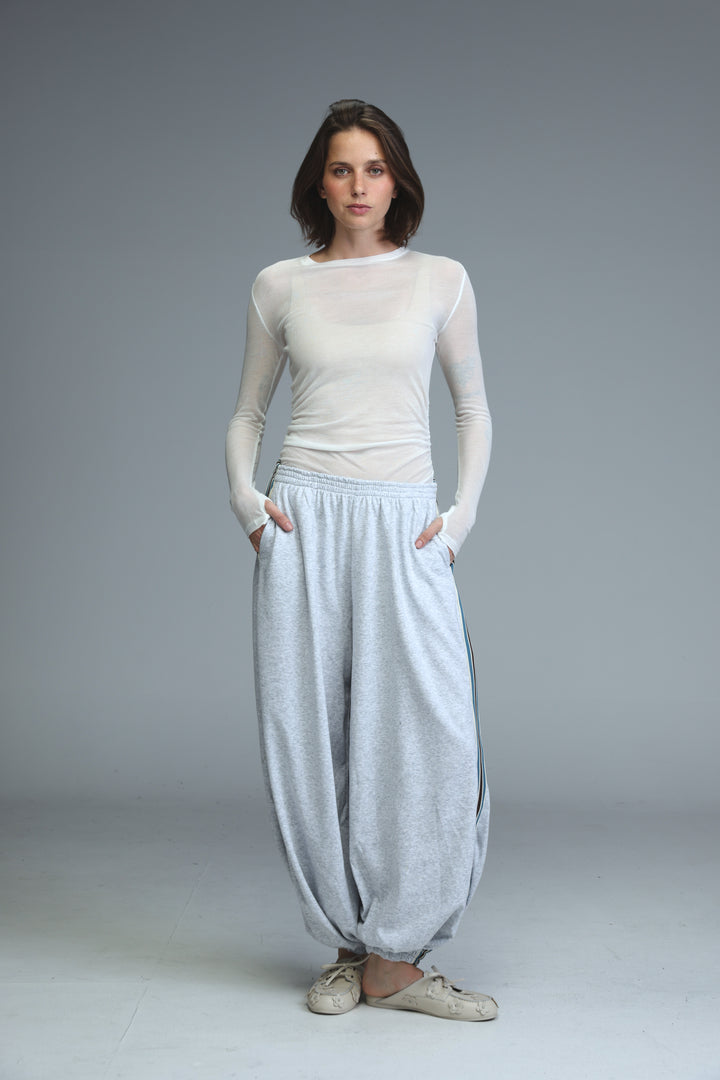 Ballooning grey striped joggers shown from the front with loose fit and subtle textured side stripes