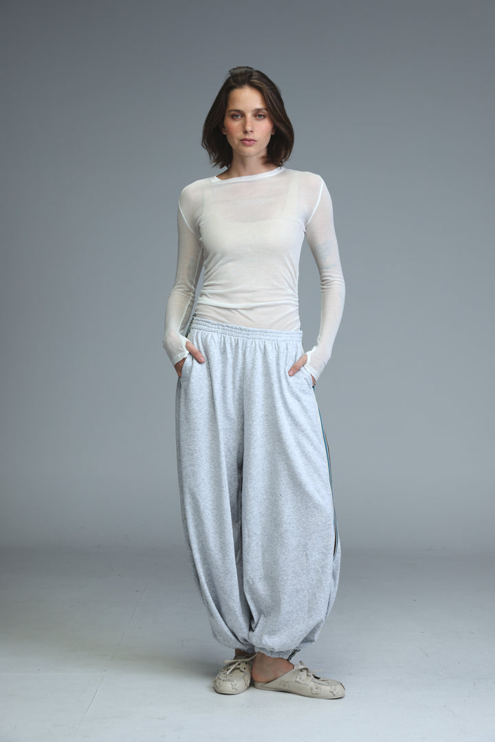 Light blue loose-fitting harem pants with elastic waistband and soft textured fabric shown from the front