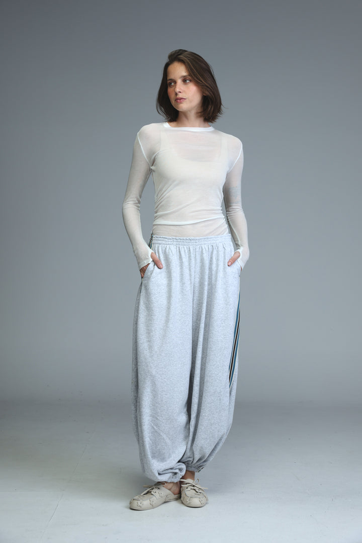 Ballooning grey striped joggers with vertical black stripes shown from the front in a loose fit design