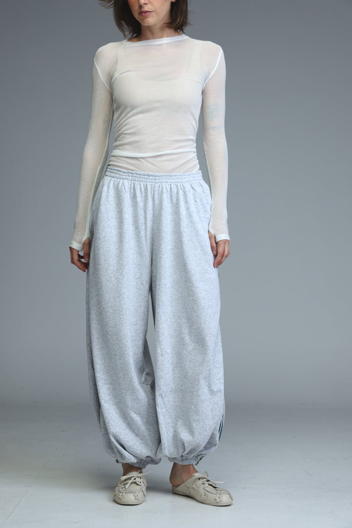 Ballooning grey striped joggers with loose fit, elastic waistband, and subtle textured pattern in front view