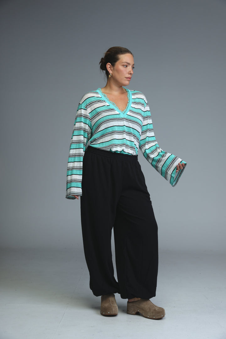 A glow grey striped shirt with teal and white stripes and a v-neckline shown from the front