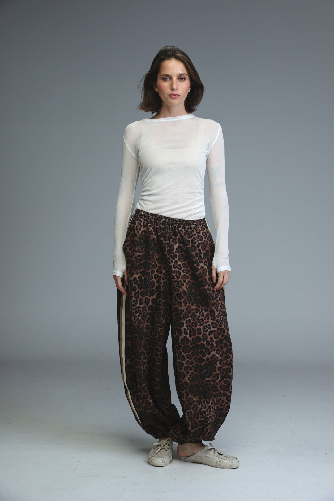 Brown leopard-print wide-leg ballooning joggers with a side stripe detail shown from the front