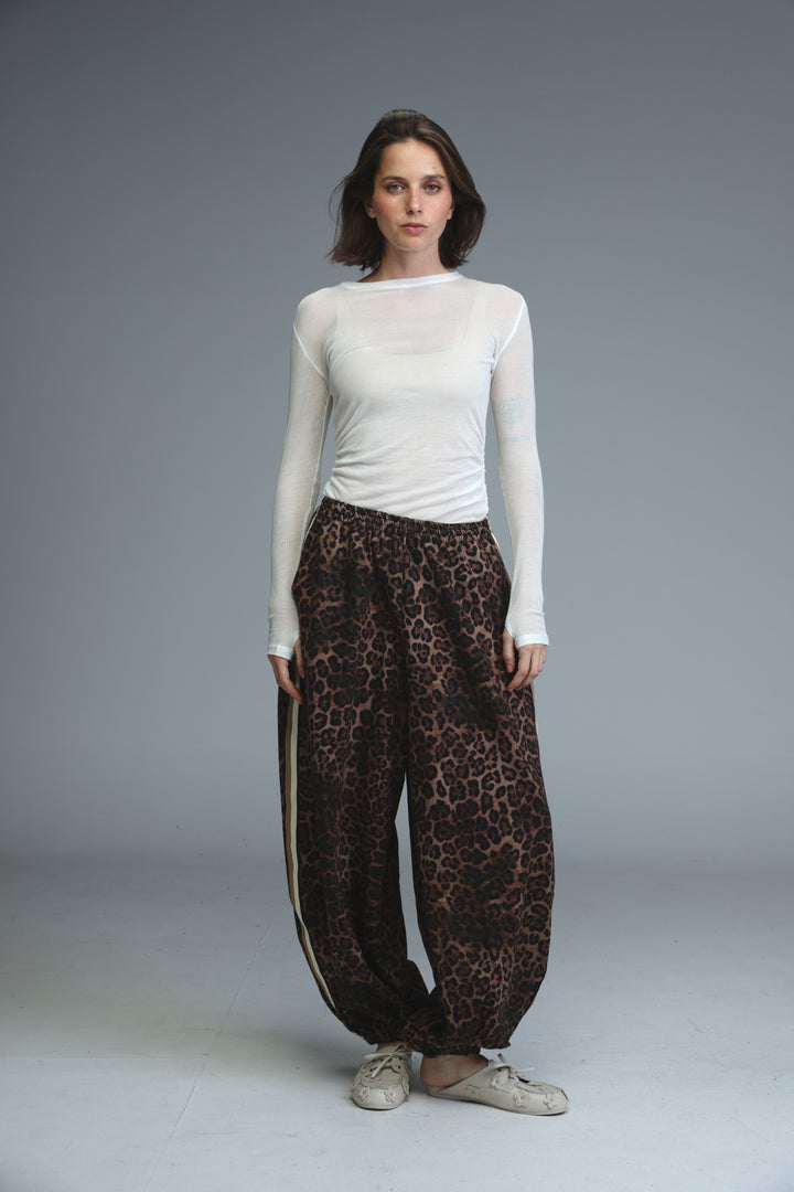 Brown leopard-print wide-leg ballooning joggers with a side stripe detail shown from the front