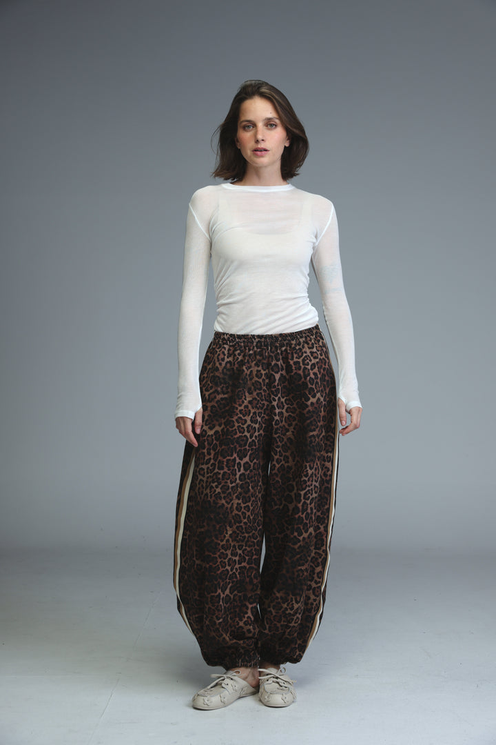Ballooning leopard striped joggers with wide legs elastic waist bold brown and black leopard print and beige side stripes front view