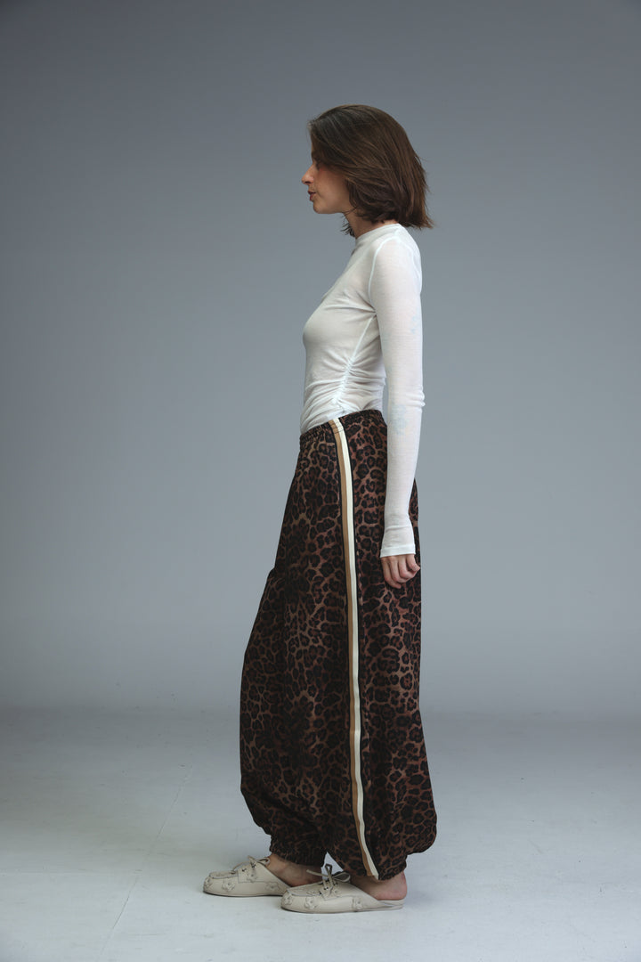 Ballooning leopard striped joggers with beige vertical stripe down the side shown from the front