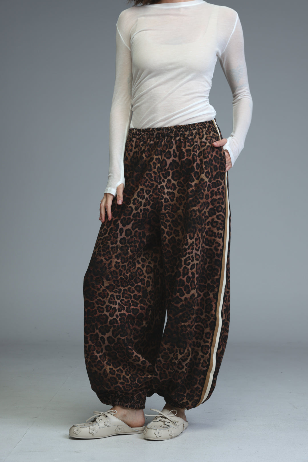 Ballooning leopard striped joggers with wide legs and a visible side stripe detail shown from the front