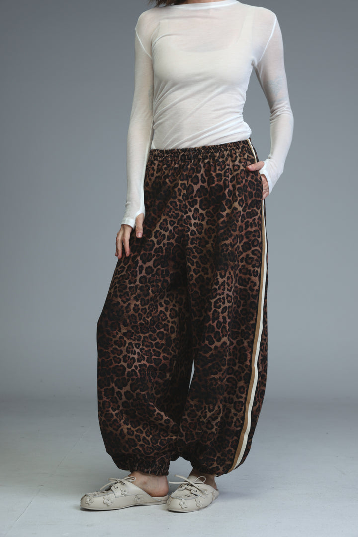 Ballooning leopard striped joggers with wide legs and a visible side stripe detail shown from the front